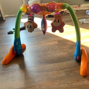 Infant lay under toy